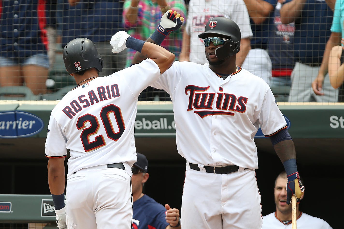 Eddie Rosario celebrated with teammate Miguel Sano after hitting a tie-breaking home run in the eighth inning against Detroit, lifting the Twins over the Tigers 5-4 at Target Field on Sunday.