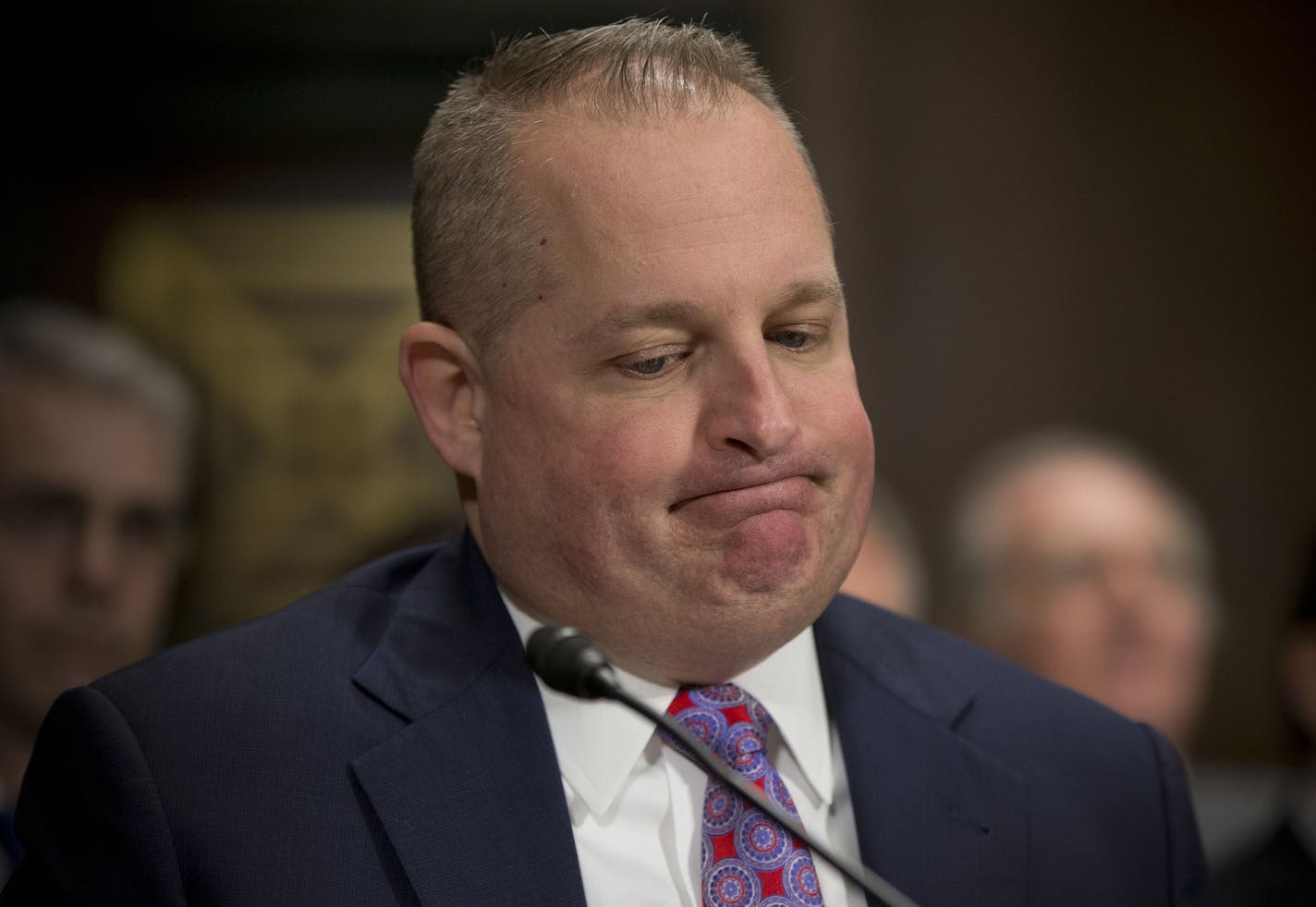 John J. Mulligan, executive Vice President and Chief Financial Office of the Target Corporation, listens on Capitol Hill in Washington, Tuesday, Feb. 4, 2014, while testifying before the Senate Judiciary Committee hearing on data breaches and combating cybercrime .