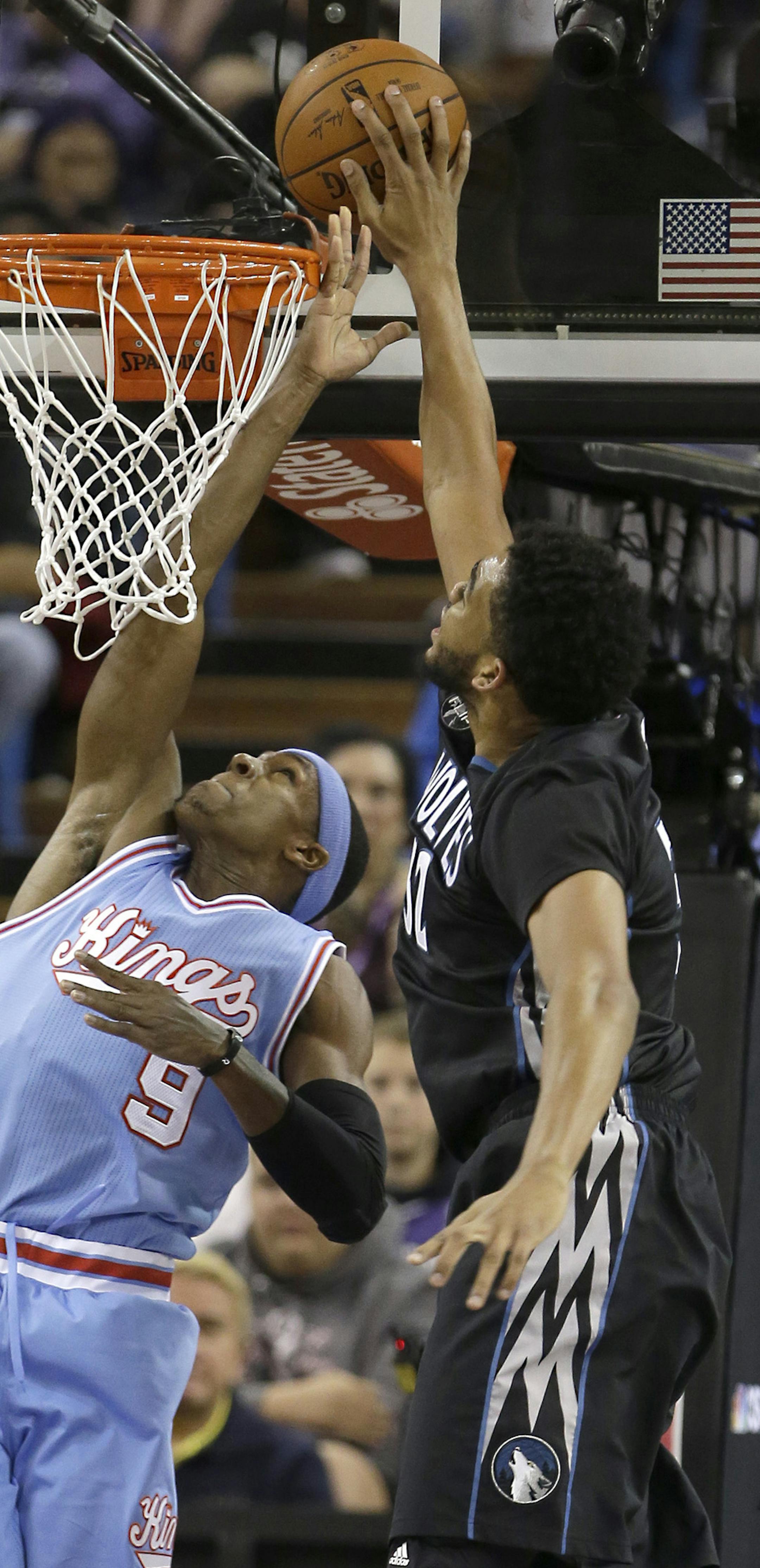 Sacramento Kings guard Rajon Rondo, left, has his shot blocked by Minnesota Timberwolves center Karl-Anthony Towns during the first quarter of an NBA basketball game in Sacramento, Calif., Friday, Nov. 27, 2015.(AP Photo/Rich Pedroncelli)