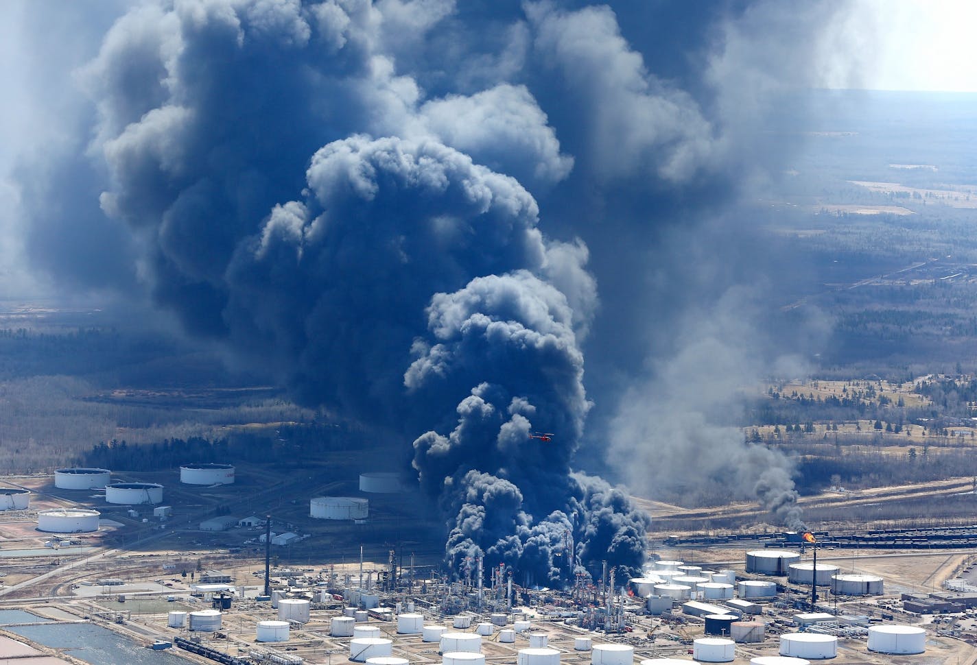 The oil refinery fire in Superior, Wis., threw thick, black smoke into the sky after an explosion and fire in April.