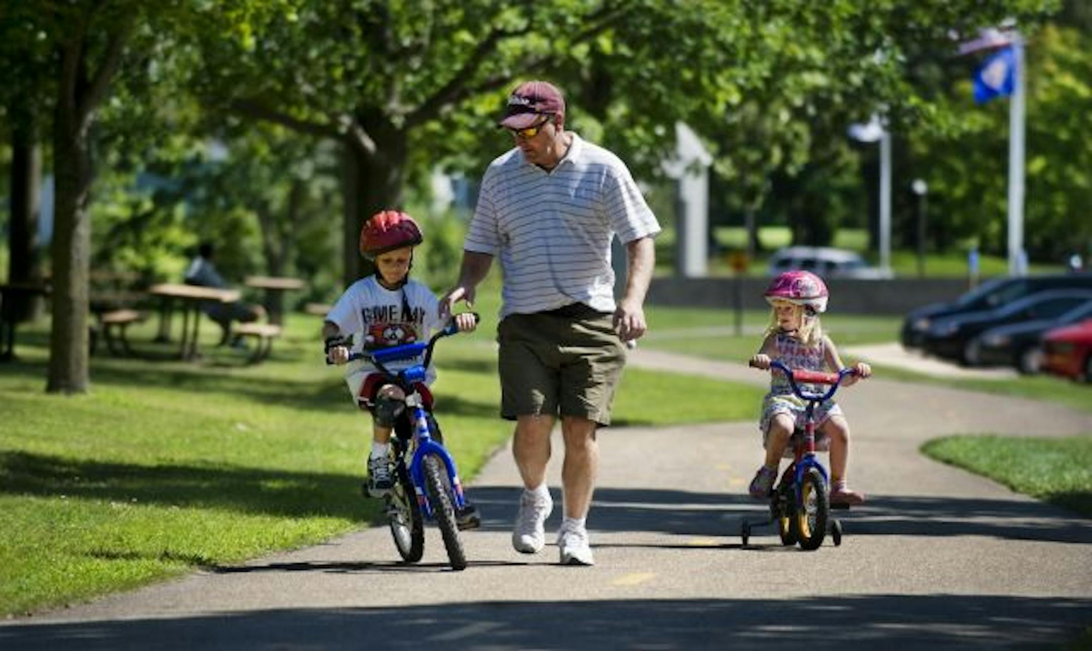 Steve Riley kept a close eye on his 6-year-old son Matt as he tried bicycling without training wheels on a path at Cleary Lake Regional Park in Prior Lake. Matt's 4-year-old sister, Hannah, kept up.