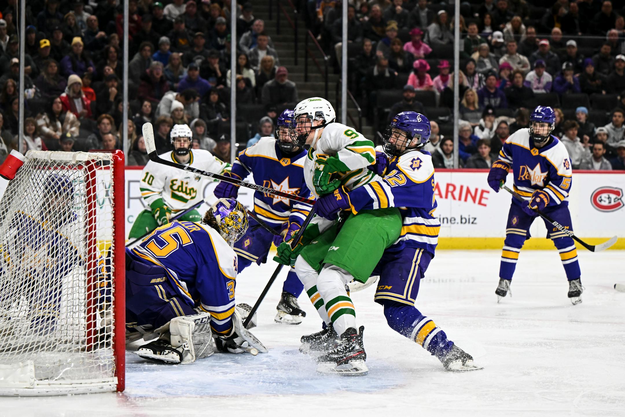 Edina forward Mason West (9) scores a goal against Cretin-Derham Hall goaltender Leo Miller (35) during the second period.