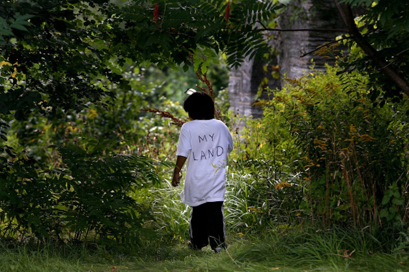 September 5, 2008 - Minneapolis MN - Nunpa Dion White, 6, made his way around the Coldwater Spring grounds before he went before a crowd with his grandmother Faith Bad Moccasin for a press conference regarding the re-occupation by the Oceti Sakowin (Seven Council Fires) of the Dakota Oyate on the Coldwater Spring and the surrounding land. The Coldwater Spring site is an abandoned property of the defunct Bureau of Mines.