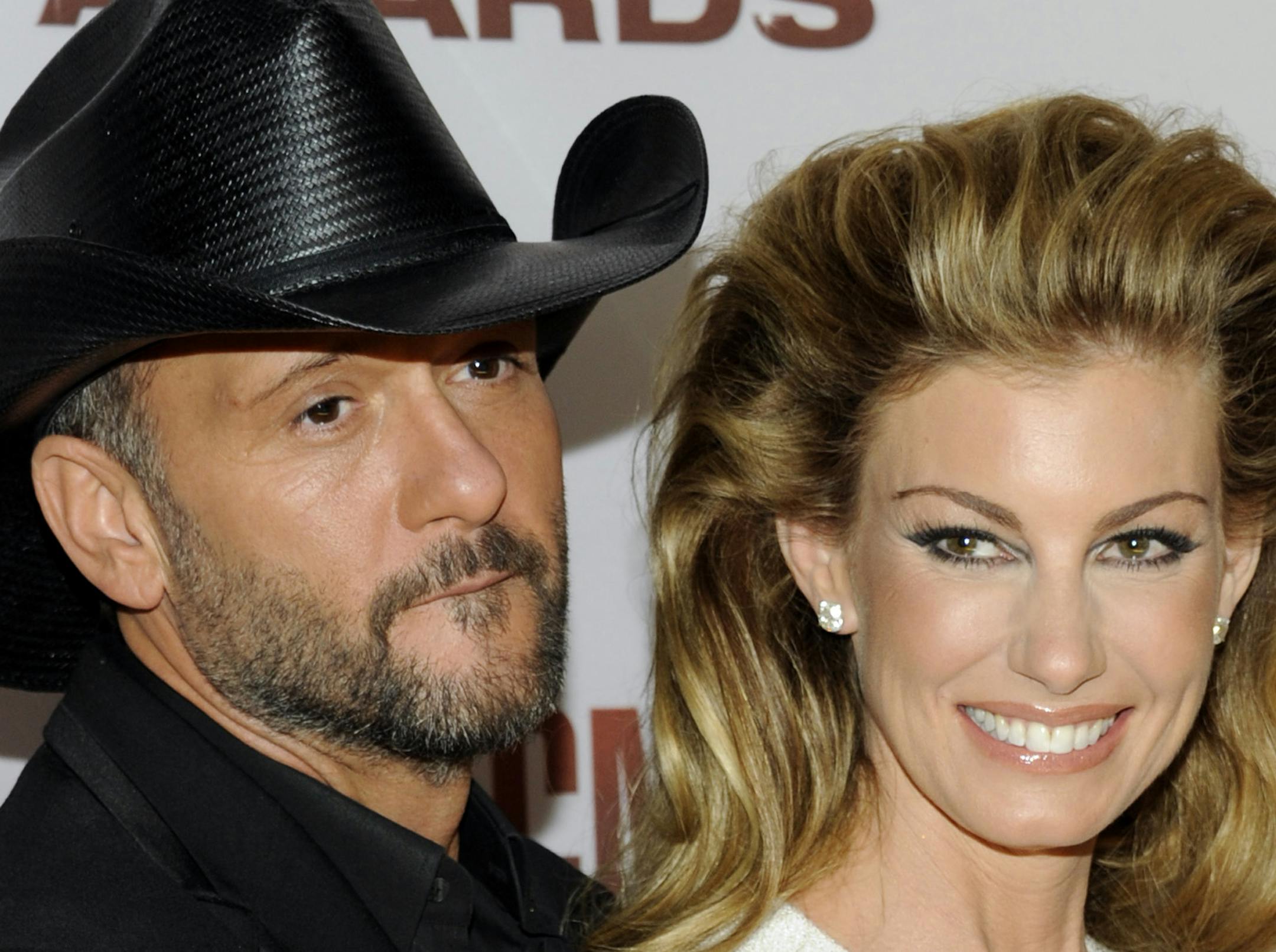 FILE - This Nov. 9, 2011 file photo shows country singers Tim McGraw, left, and his wife Faith Hill at the 45th Annual CMA Awards in Nashville, Tenn. McGraw and Hill are brushing off divorce rumors as they power into a new round of ìSoul2Soulî duet performances in Las Vegas. The country music royals sat close and joked with each other about tabloid headlines during a round table interview with reporters before their Friday Nov. 15, 2013, show at the Venetian casino. (AP Photo/Evan Agos