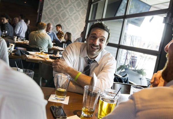Jake Raymond of Long Lake enjoys beers with friends at The Loop West End in St. Louis Park March 26, 2015. (Courtney Perry)