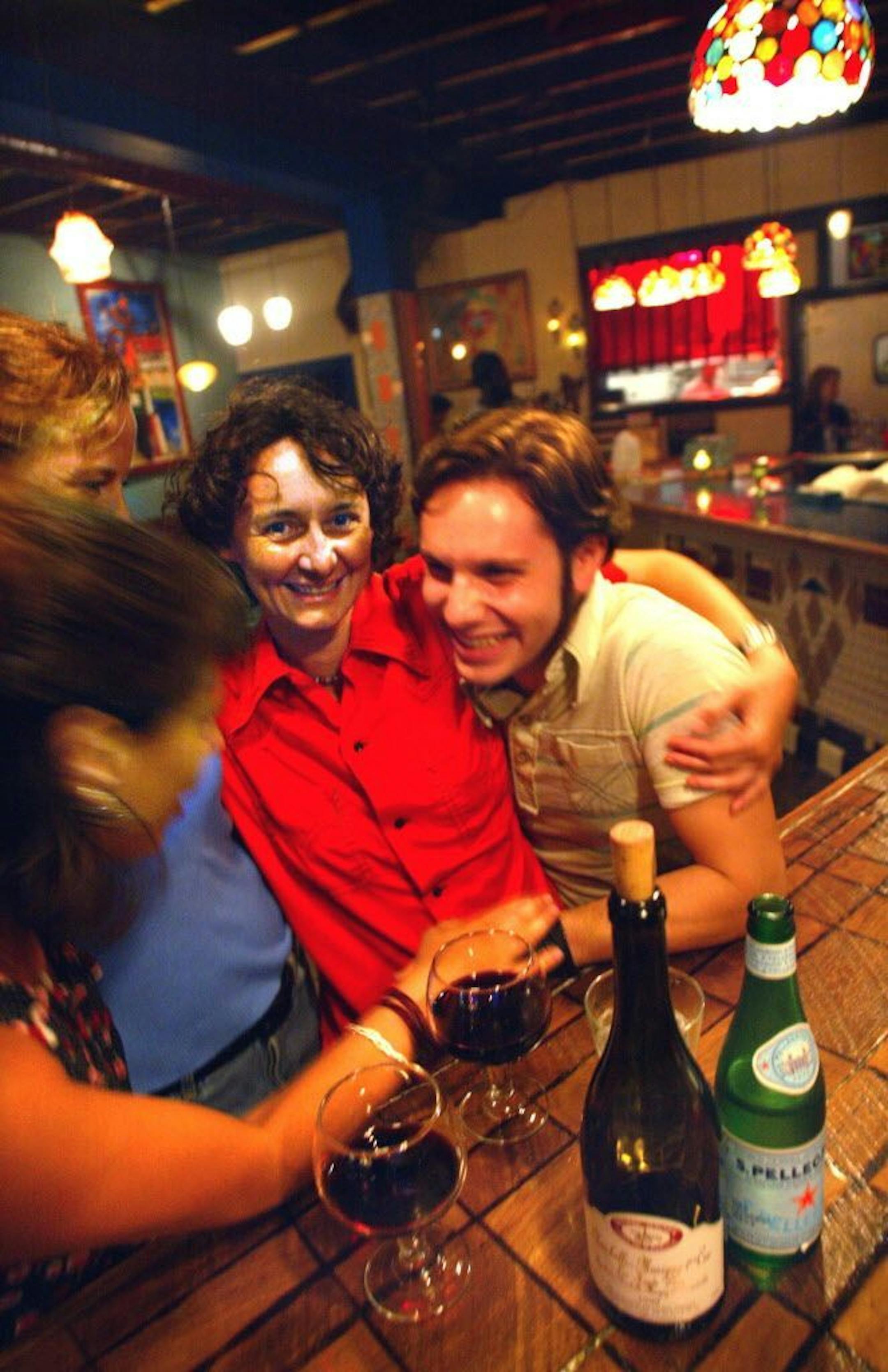 Kim Bartmann, center in red, gets together with friends at Barbette's on Lake Street in Minneapolis. From left bottom is Susan Scalf, left top is Dayna Delaney, Bartmann and Peter Rousseau. All are from Minneapolis.