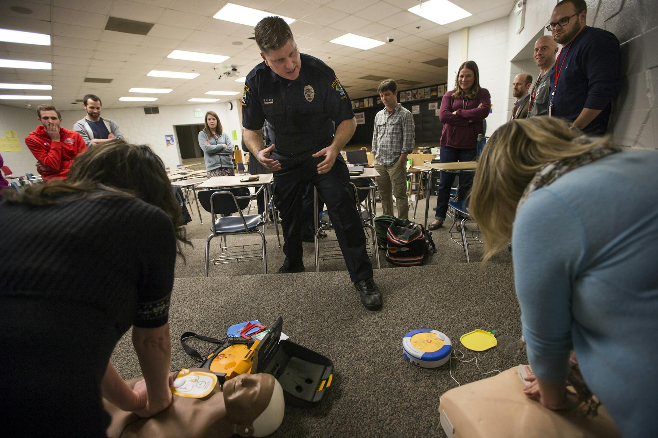 Officer Bryan Platz sang the song "Staying Alive" to help keep the pace of the the CPR administered by teachers during a class for a group of teachers at Coon Rapids High School on Thursday, February 11, 2016, in Coon Rapids, Minn. ] RENEE JONES SCHNEIDER • reneejones@startribune.com