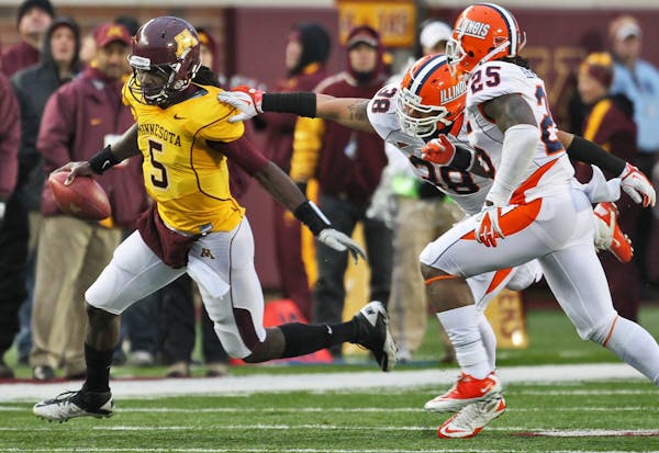Gophers quarterback MarQueis Gray (5) ran away from Illinois tacklers Saturday, Nov. 26, 11.