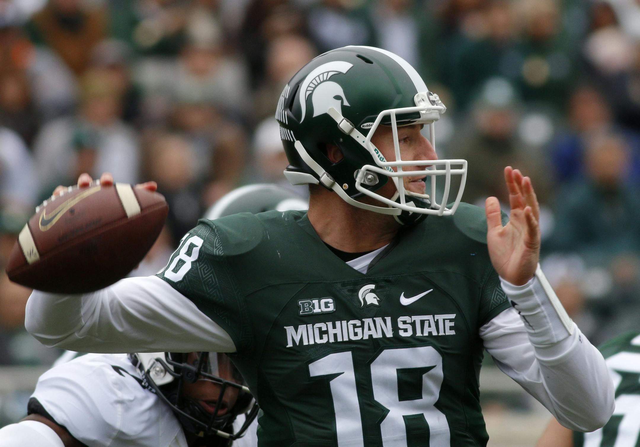 Michigan State quarterback Connor Cook throws a pass during the first quarter of an NCAA college football game against Purdue, Saturday, Oct. 3, 2015, in East Lansing, Mich. Michigan State won 24-21. (AP Photo/Al Goldis)