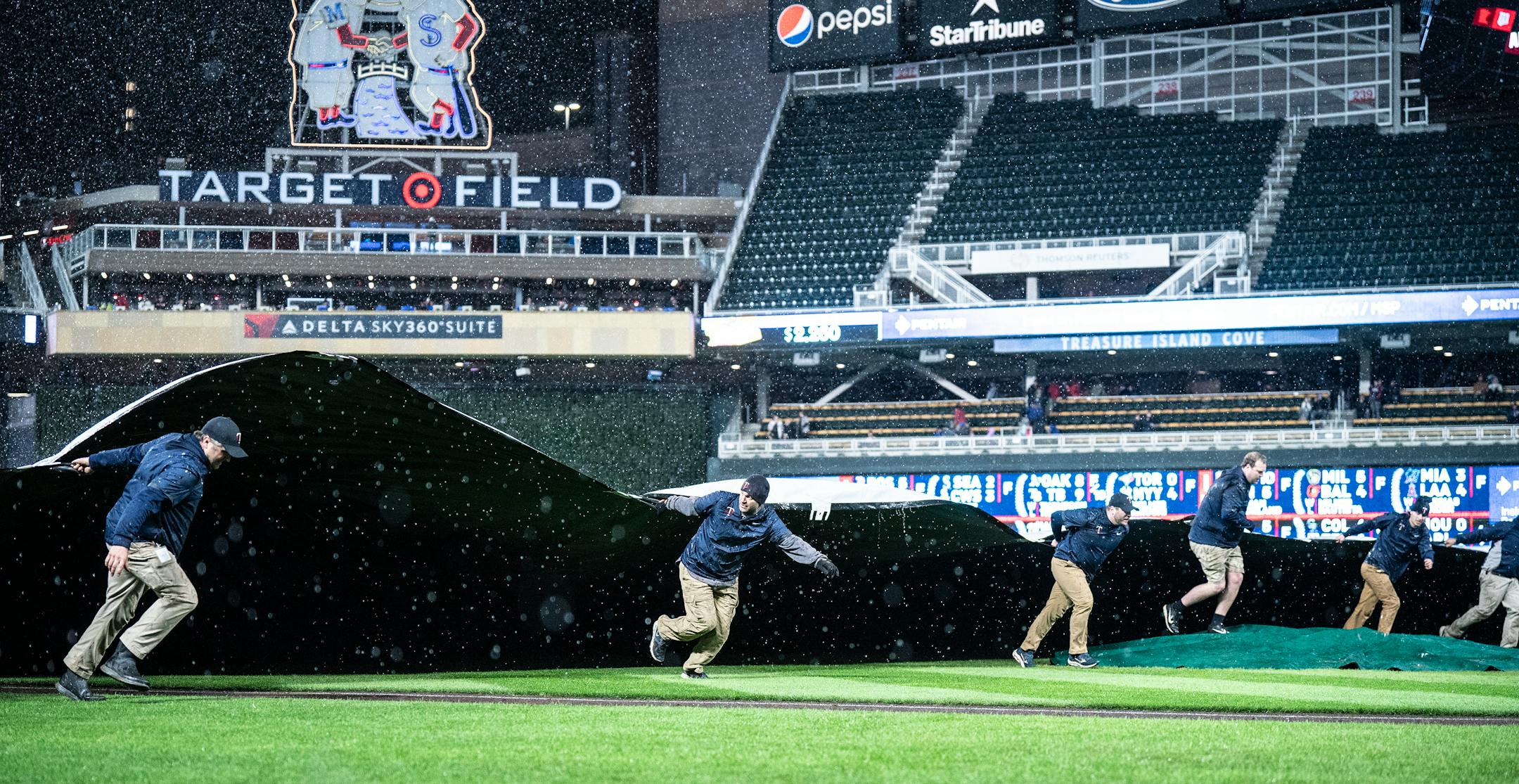 The Twins grounds crew rolled out the tarp in the eight-inning has heavy rain fell in Minneapolis.