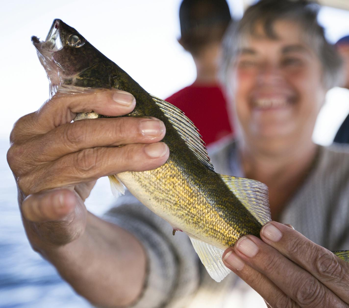 Joyce Shackelford of Des Moines poses for a photo with a walleye she caught (and then released) during a fishing expedition with Twin Pines Resort on Mille Lacs Lake Monday, August 3, 2015. ] LEILA NAVIDI leila.navidi@startribune.com /