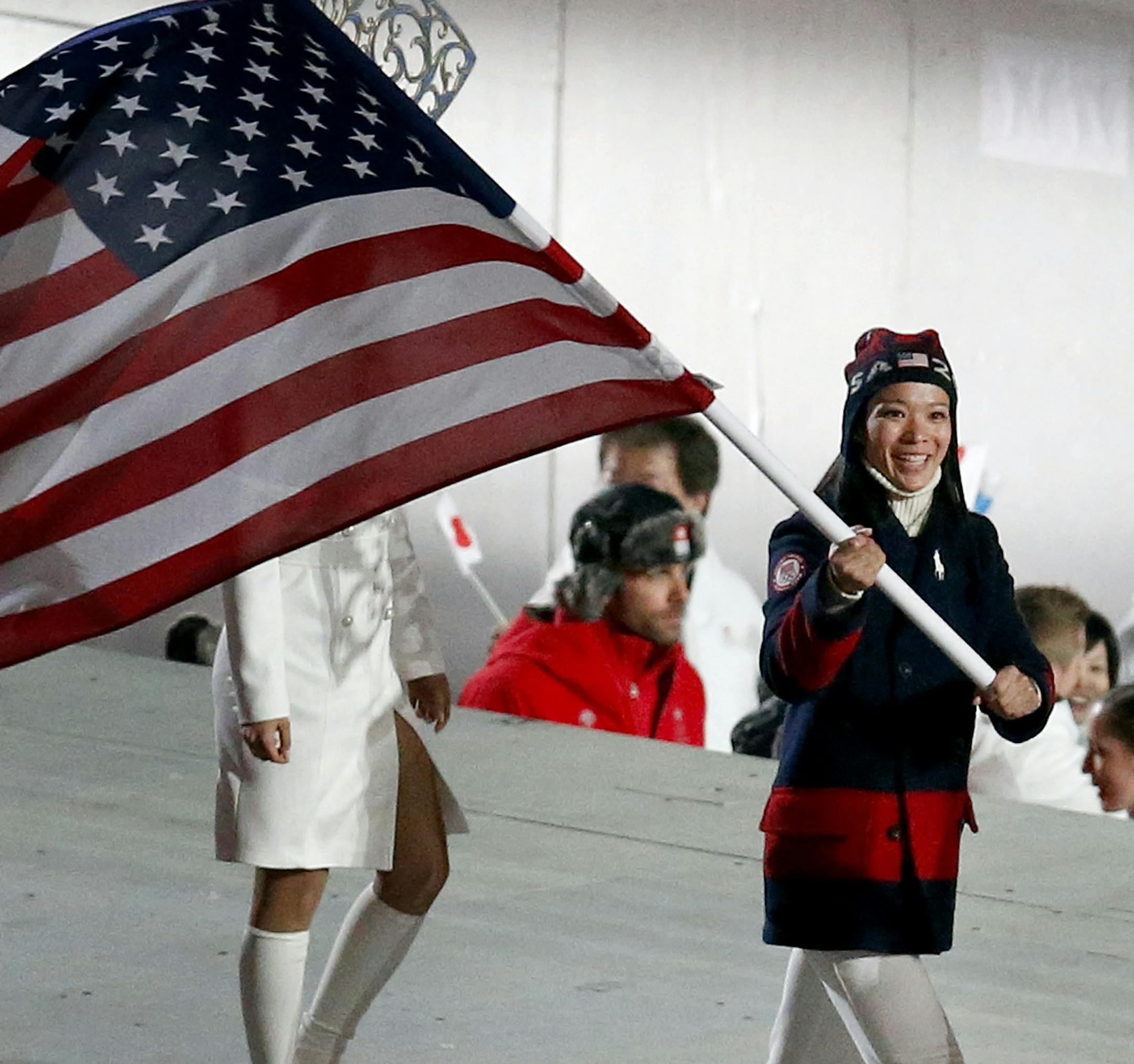 Julie Chu carried in the USA flag during Olympic closing ceremonies at Fisht Stadium on Sunday. ] CARLOS GONZALEZ cgonzalez@startribune.com - February 23, 2013, Sochi, Russia, Sochi 2014 Winter Olympics, Fisht Stadium, Olympic Closing Ceremonies