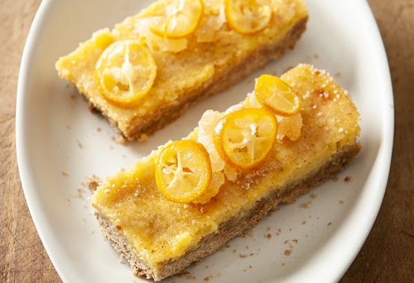 Honey-Kissed Lemon Bars are topped with kumquats.