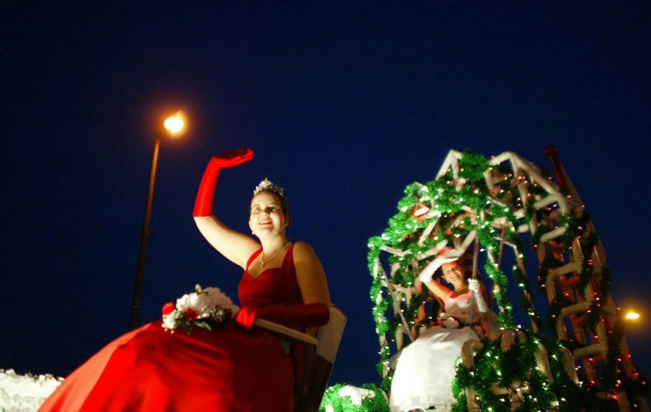 Minneapolis,MN;7/23/03:Left to right:Raspberry Princess Beth Williams and Raspberry Queen Renee Drinkwine of the Hopkins Raspberry Festival greet their fans during the Torchlight Parade.