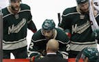 Minnesota Wild defenseman Marco Scandella (6) and right wing Nino Niederreiter (22) listen to head coach Mike Yeo during the third period of Game 3 in