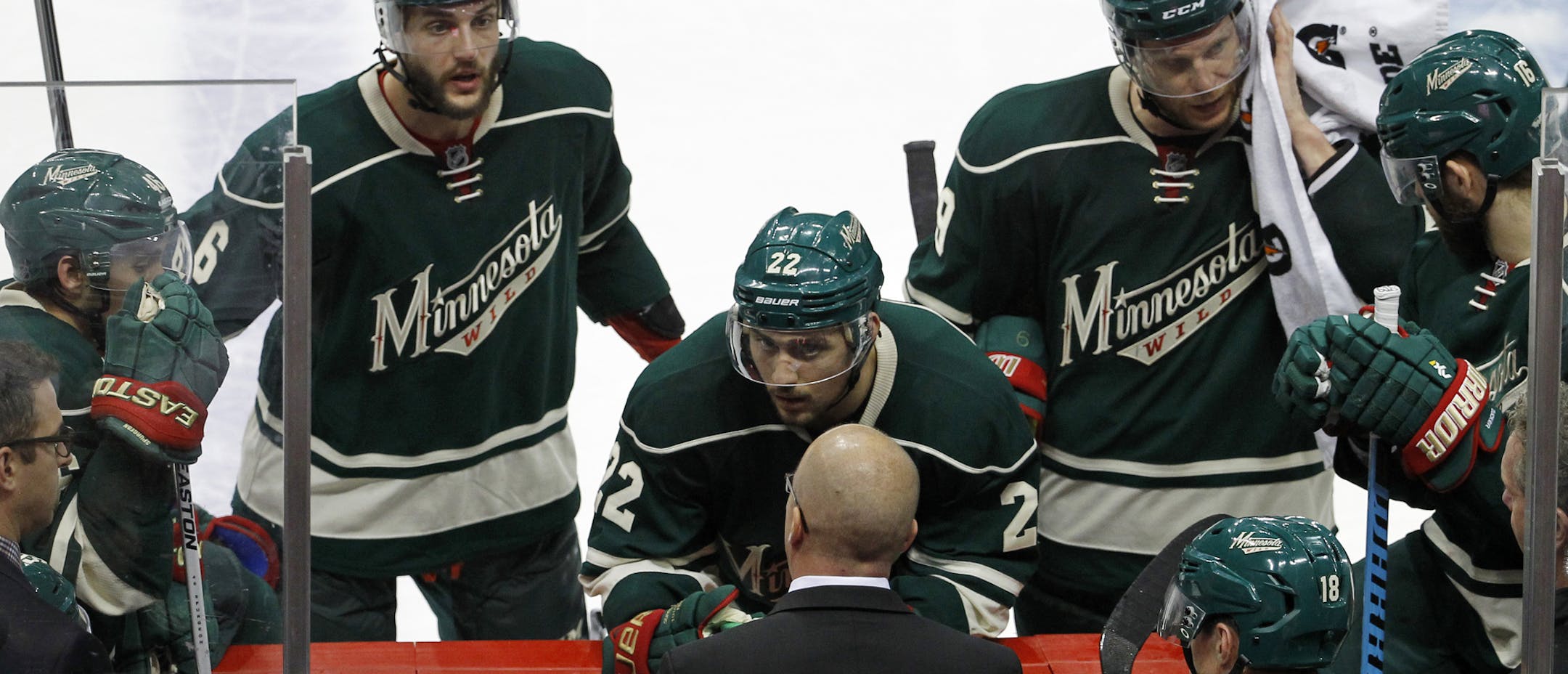 Minnesota Wild defenseman Marco Scandella (6) and right wing Nino Niederreiter (22) listen to head coach Mike Yeo during the third period of Game 3 in the second round of the NHL Stanley Cup hockey playoffs against the Chicago Blackhawks in St. Paul, Minn., Tuesday, May 5, 2015. The Blackhawks won 1-0. (AP Photo/Ann Heisenfelt)