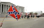 A woman waves a rebel flag during a parade honoring the 200th birthday of Robert E. Lee, Saturday, Jan. 20, 2007, in Montgomery, Ala. (AP Photo/Rob Ca