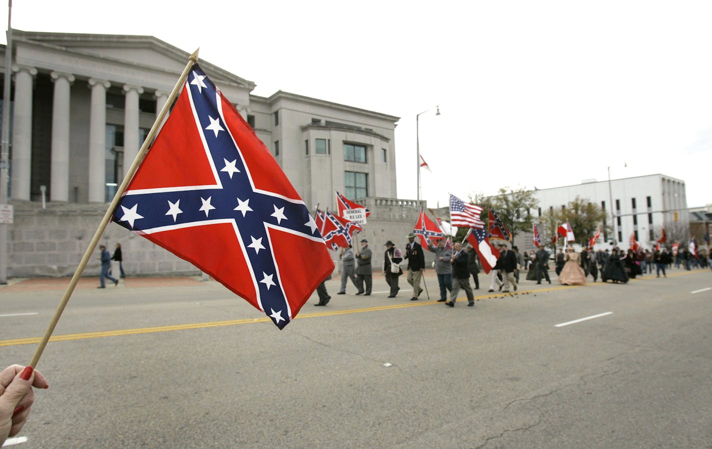 A woman waves a rebel flag during a parade honoring the 200th birthday of Robert E. Lee, Saturday, Jan. 20, 2007, in Montgomery, Ala. (AP Photo/Rob Carr) ORG XMIT: OTKRC101