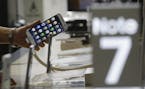 A customer holds a Samsung Electronics Galaxy Note 7 smartphone at the headquarters of South Korean mobile carrier KT in Seoul, South Korea, Friday, S