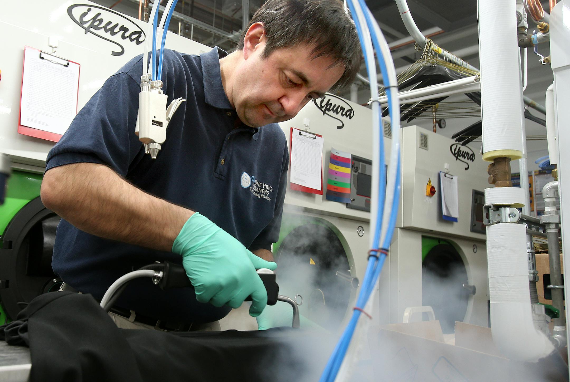 Store manager Amjad Khan steamed out a stain at CD One Price Cleaners in Hopkins. The Chicago-based company plans to open stores across the Twin Cities.