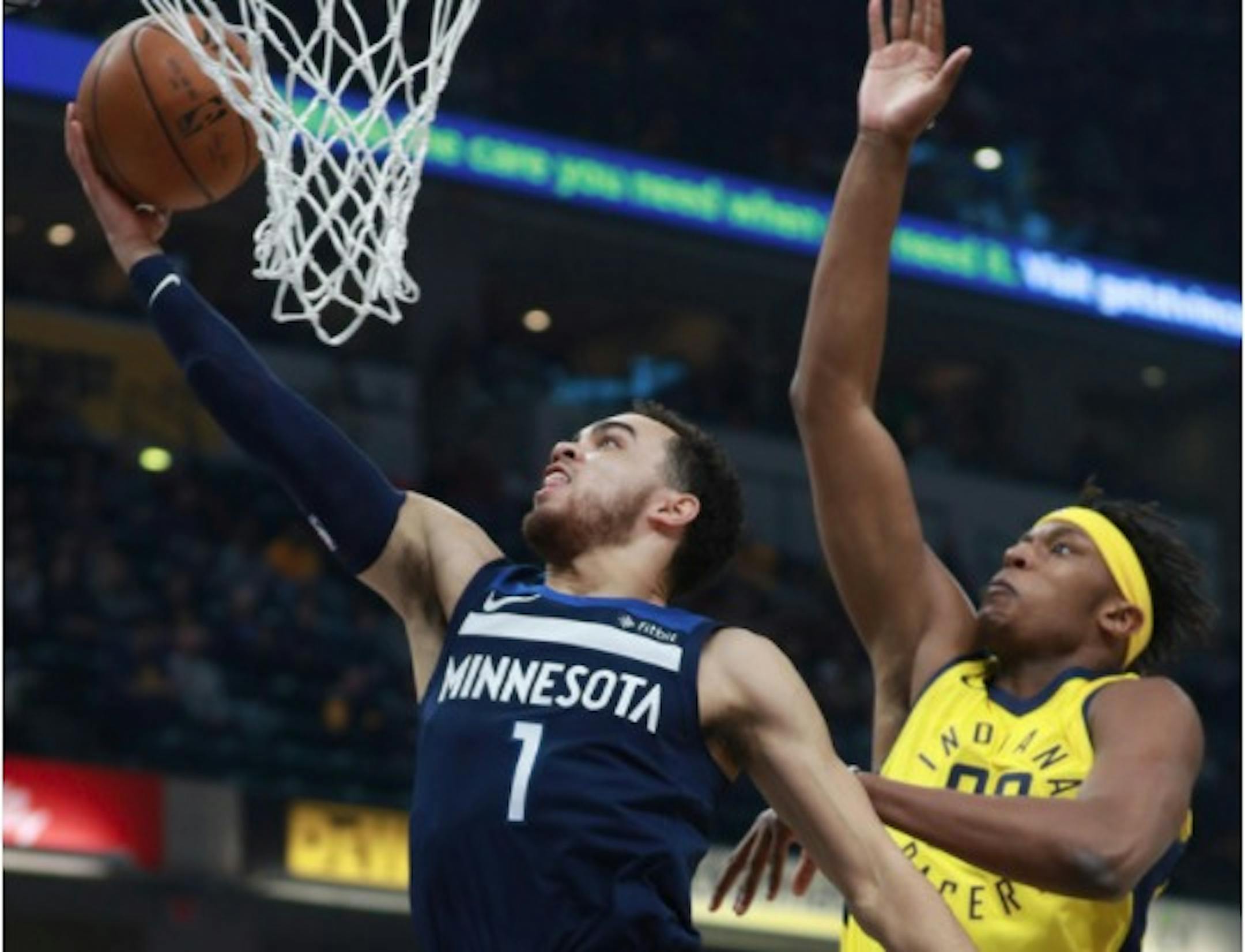 Minnesota Timberwolves guard Tyus Jones (1) shoots the basketball defended by Indiana Pacers center Myles Turner in the first half of an NBA basketball game, Sunday, Dec. 31, 2017, in Indianapolis.