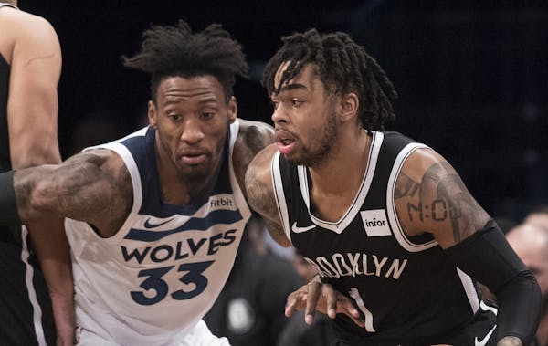 Brooklyn Nets guard D'Angelo Russell (1) drives to the basket against Minnesota Timberwolves forward Robert Covington (33) during the first half of an
