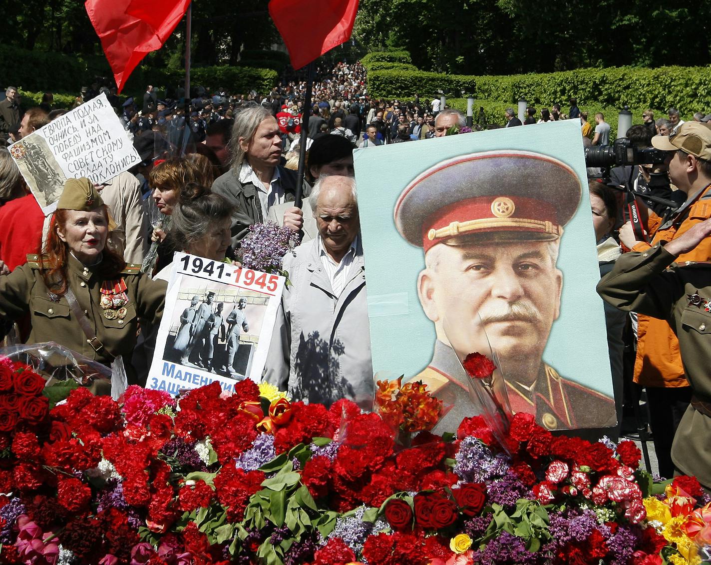 Communists stand with a portrait of Soviet dictator Josef Stalin during a ceremony to mark 70th anniversary of the end of WWII in front of the Memorial of the Unknown Soldier in Kiev, Ukraine, on May 9, 2015. (Stringer/NurPhoto/Sipa USA/TNS)