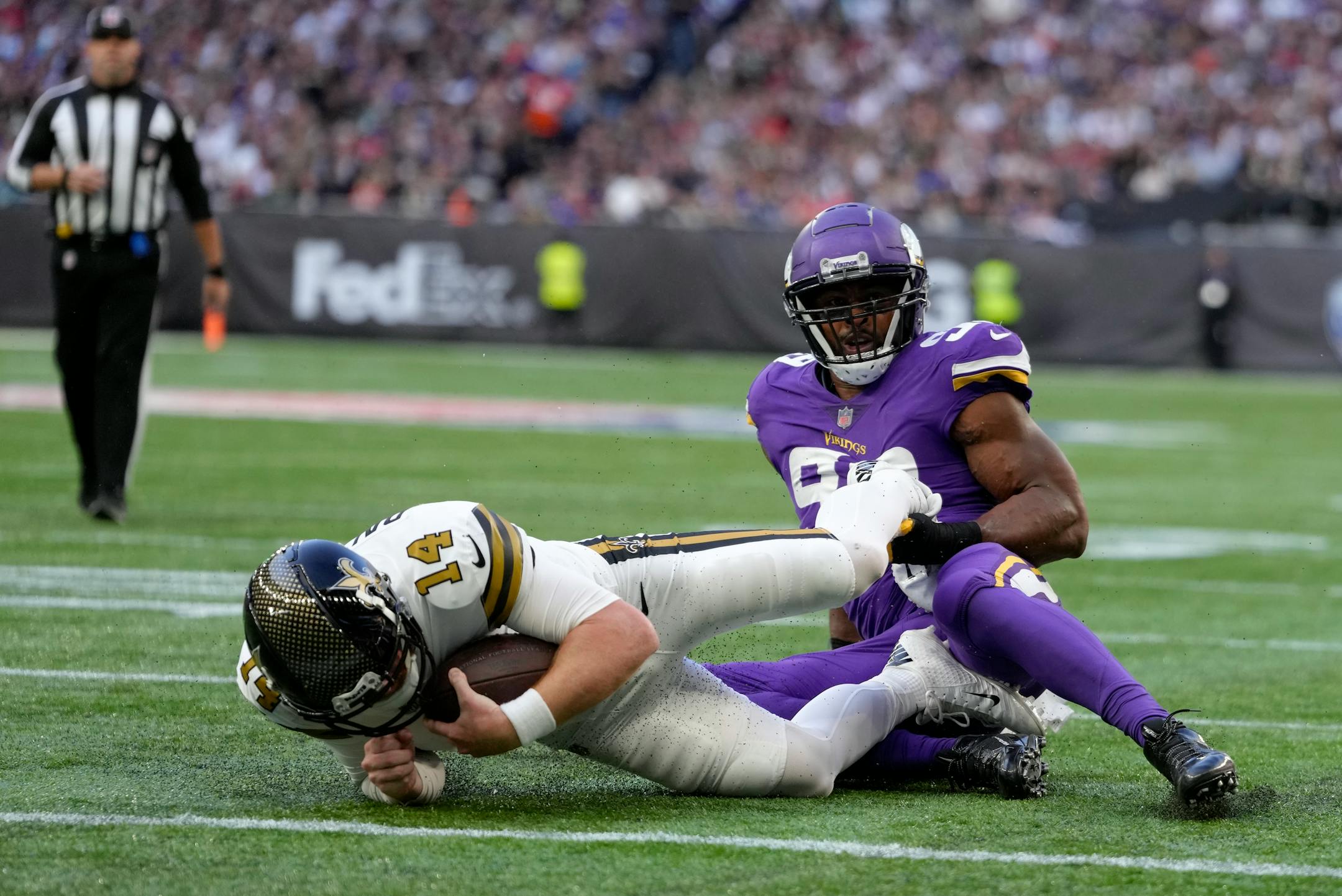 New Orleans Saints quarterback Andy Dalton (14) is tackled just short of the end zone.