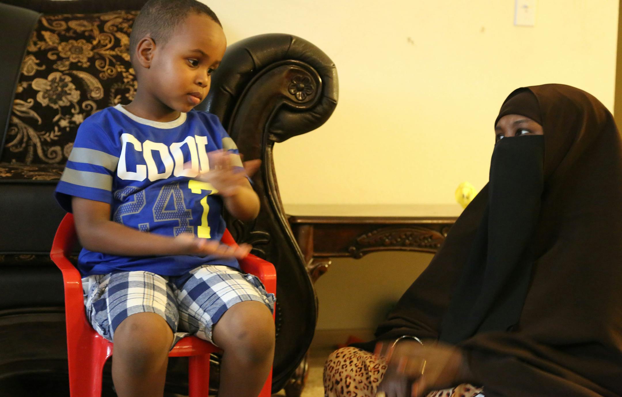 Suhayb Ali, 5, talked with his mother Fowsia Musse using sign language. ] (KYNDELL HARKNESS/STAR TRIBUNE) kyndell.harkness@startribune.com Suhayb Ali and his family in St Paul, Min., Friday, July 10, 2015.