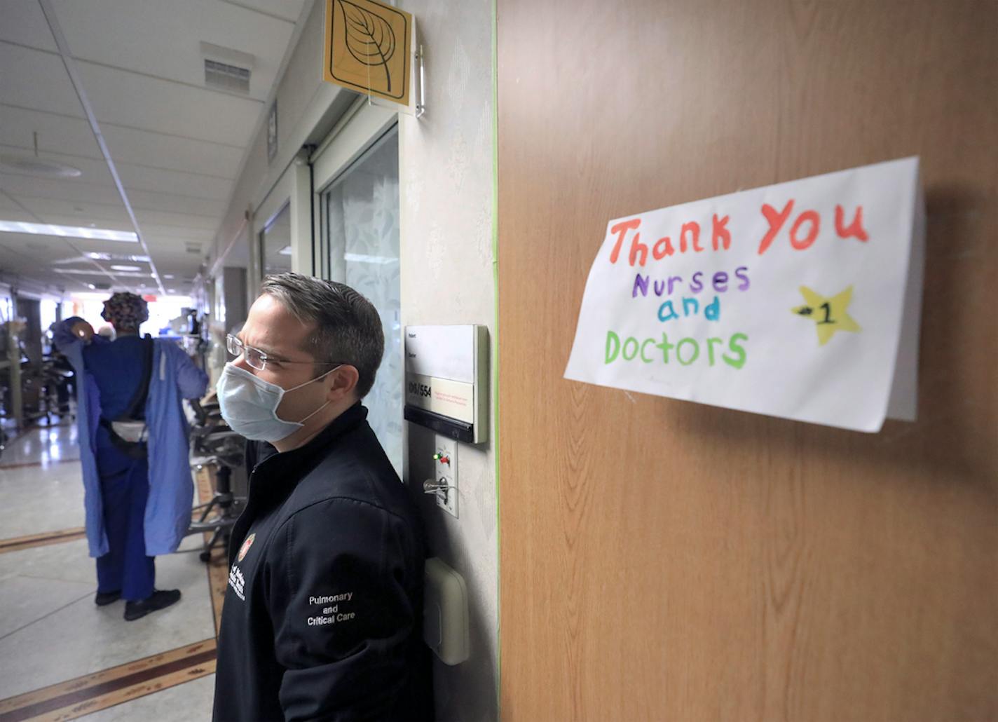 A thank you note for staff at UW Health is displayed on a wall inside a COVID-19 treatment unit as Dr. Andrew Braun, a physician on the unit, stands by in Madison, Wis. Thursday, Nov. 5, 2020.