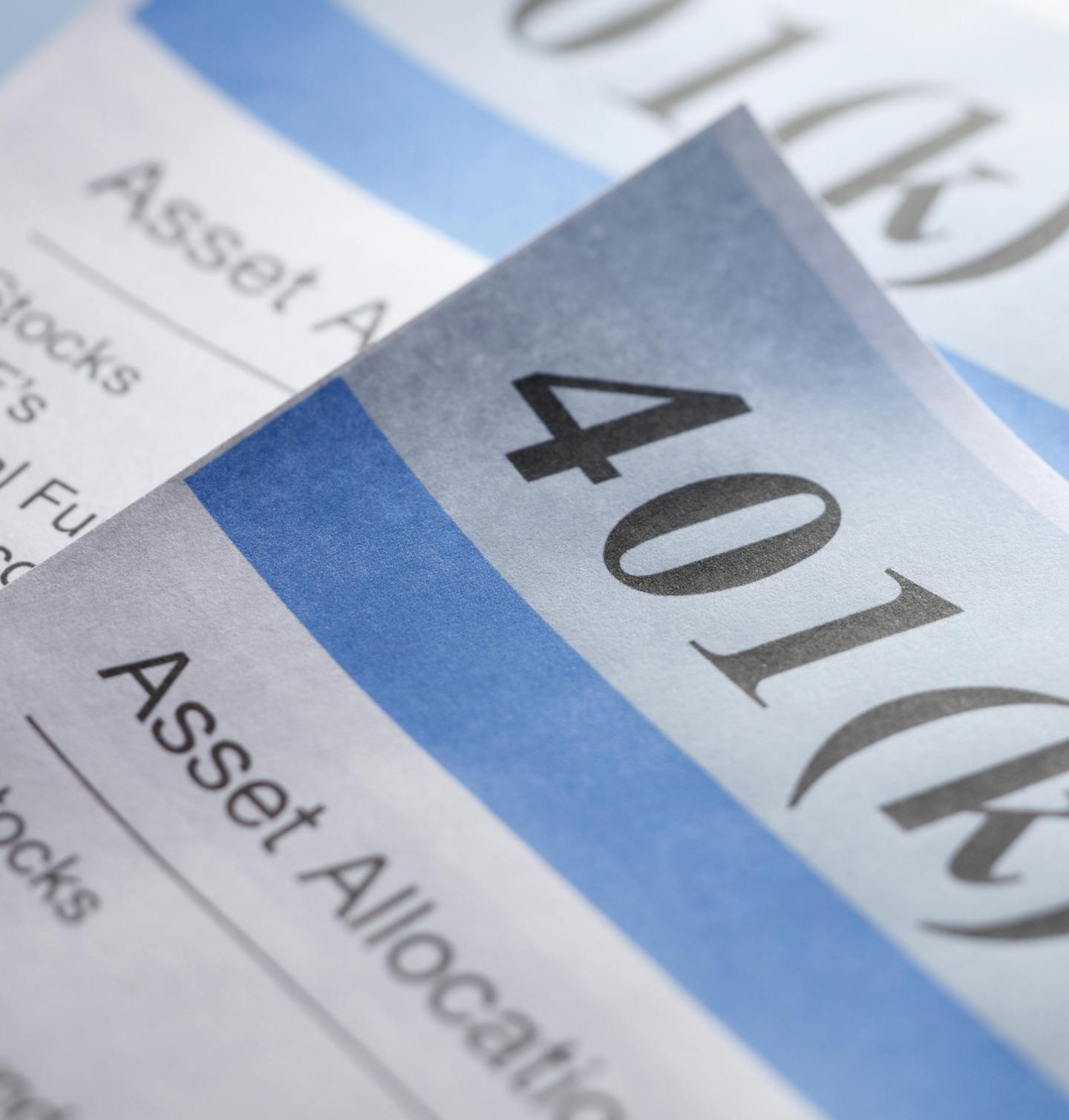 A stack of retirement account statements. Shot with shallow depth of field.