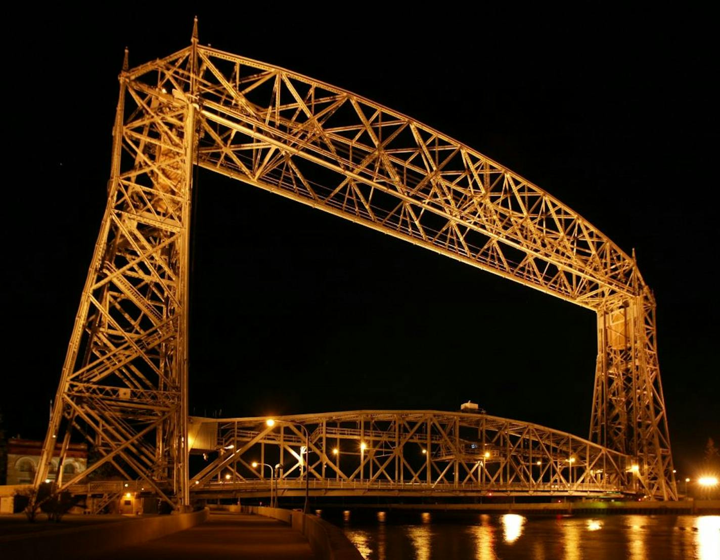 Duluth's Aerial Lift Bridge has few lights on it, but it is brilliantly illuminated from land positioned lights. The bridge is 225 feet tall, 24 foot wide roadway, sits 15 feet off the water at test and averages 5500 lifts a year.