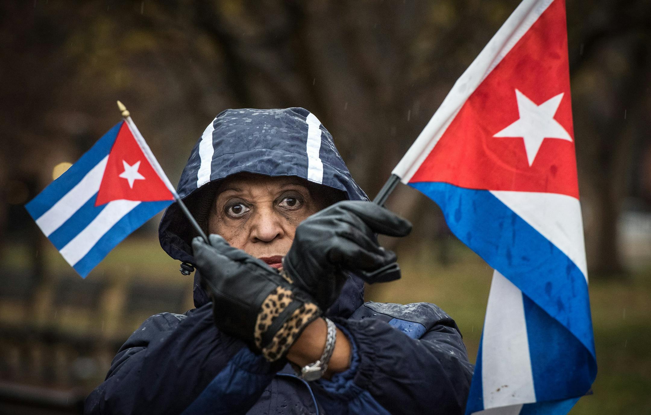 Violetta Pons of Miami, Fla., holds Cuban flags to raise awareness of continued oppression and human rights abuses by the Castro regime during a rally across the street from the White House in Washington, D.C., on Thursday, Dec. 17, 2015. (Ken Cedeno/McClatchy DC/TNS)