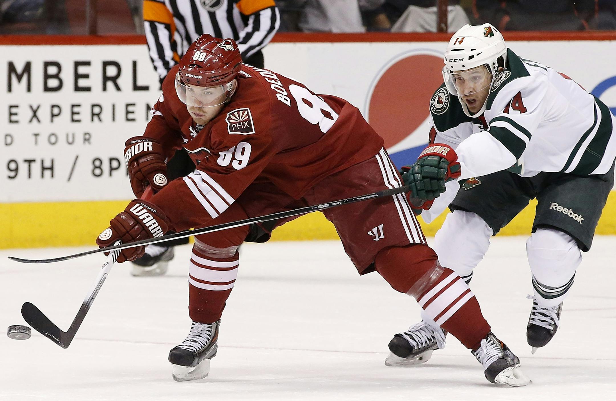 Phoenix Coyotes' Mikkel Boedker (89), of Denmark, tries to keep the puck away from Minnesota Wild's Justin Fontaine (14) during the third period in an NHL hockey game Thursday, Jan. 9, 2014, in Glendale, Ariz. The Wild defeated the Coyotes 4-1. (AP Photo/Ross D. Franklin)