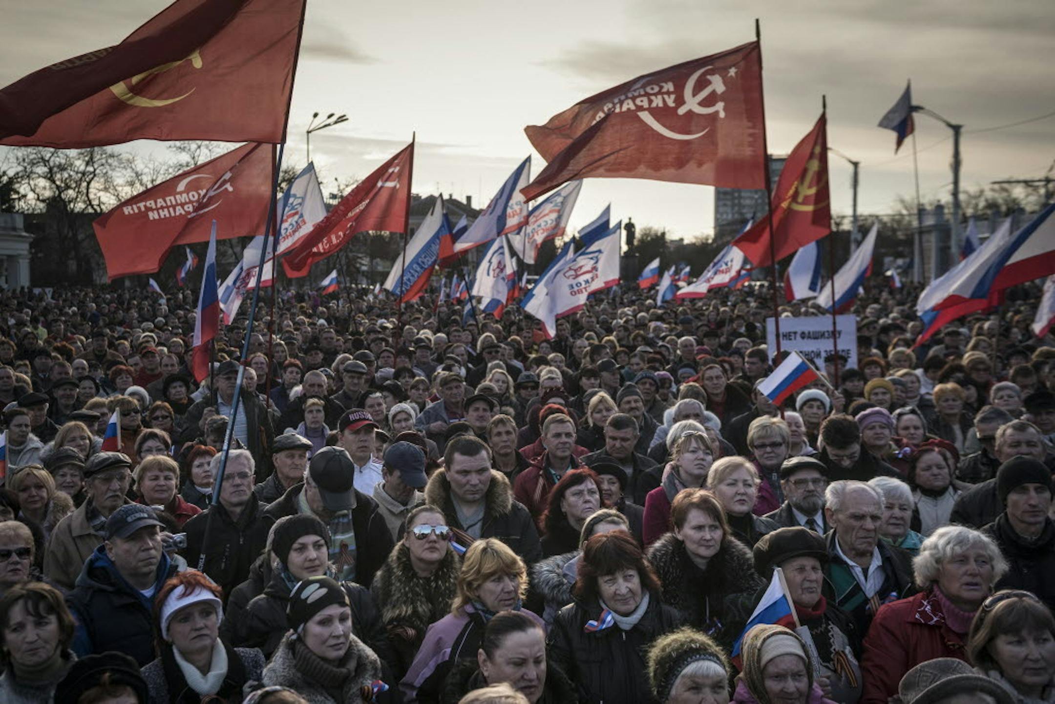 Protesters wave flags of Russia and Crimea, white white red and blue trim, at a pro-Russian rally in Yevpatoria, in the Crimea region of Ukraine, March 5, 2014.
