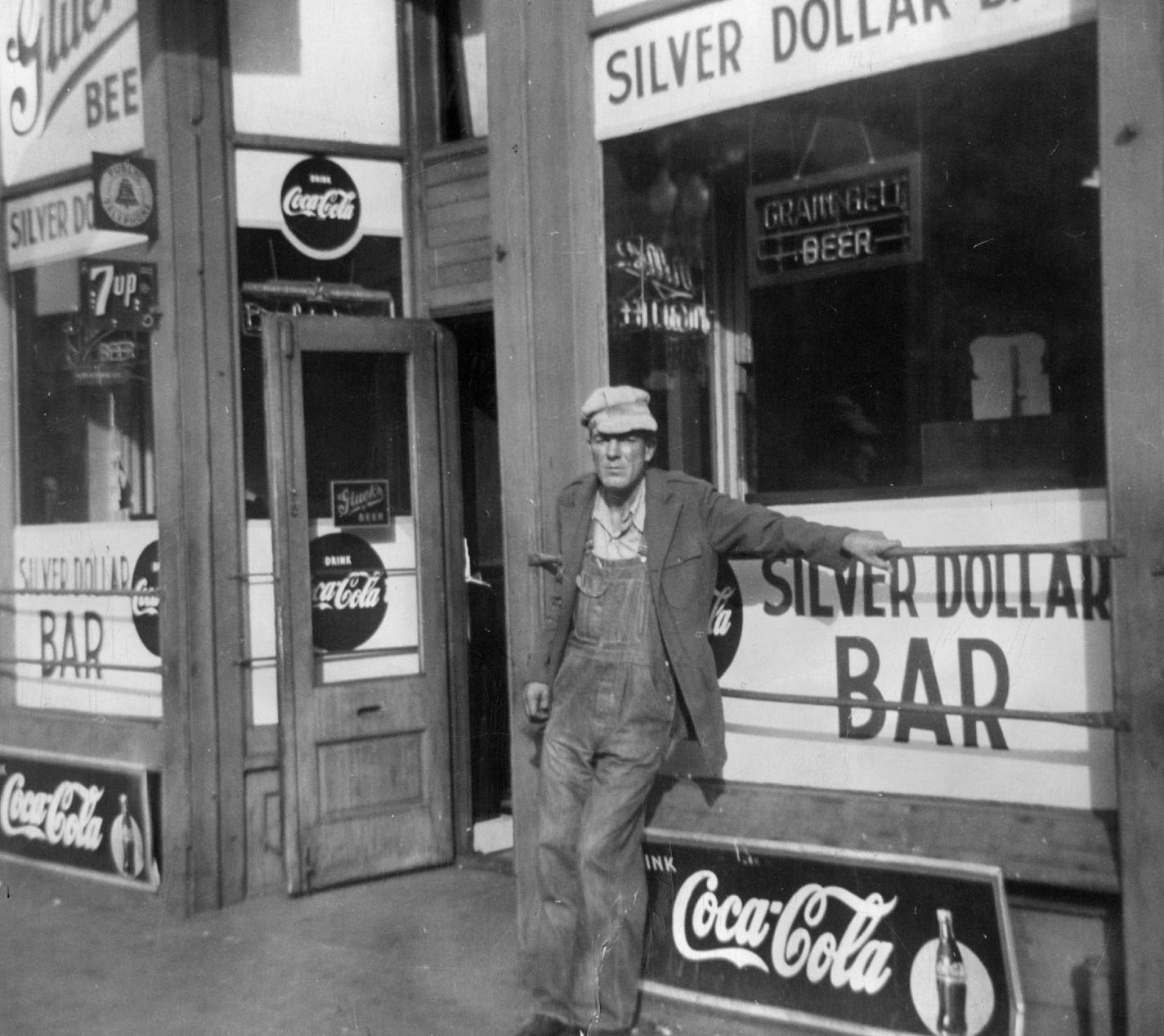 The Silver Dollar Bar and one of its habitues in 1950. In a previous time, Washington Avenue was all bars, pawnshops and flophouses.