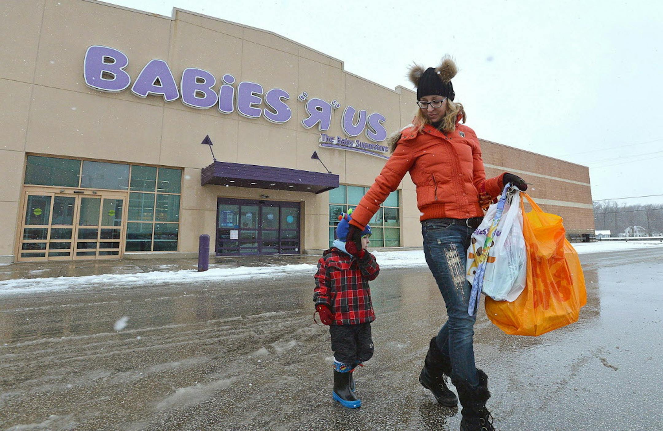 Jennifer Merva and her son Sebastian Merva, 4, leave Babies R Us in Summit Township, Pa., on Wednesday, Jan. 24, 2018, after shopping for gifts for a baby shower. As part of a Chapter 11 bankruptcy reorganization, parent company Toys R Us announced on Jan. 24 that the Summit Township store would be one of 182 stores to close over the next few months. (Christopher Millette/Erie Times-News via AP)