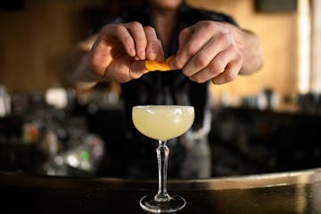 Preparing a cocktail at Tattersall Distilling in Minneapolis. (AARON LAVINSKY)