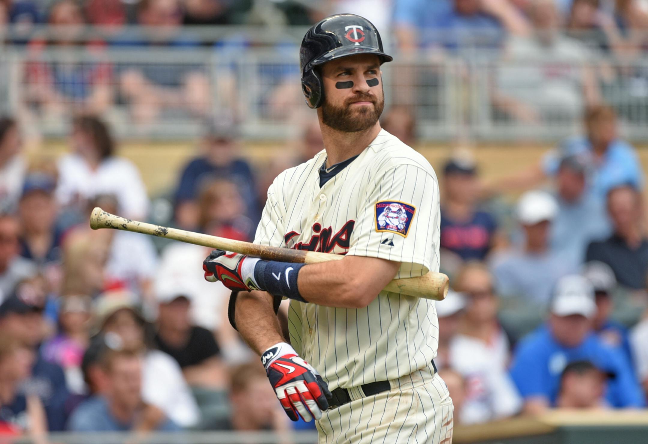 Joe Mauer heads back to the dugout after being called out on strikes against the Cubs in the fourth inning, Saturday June 20, 2015, in Minneapolis.