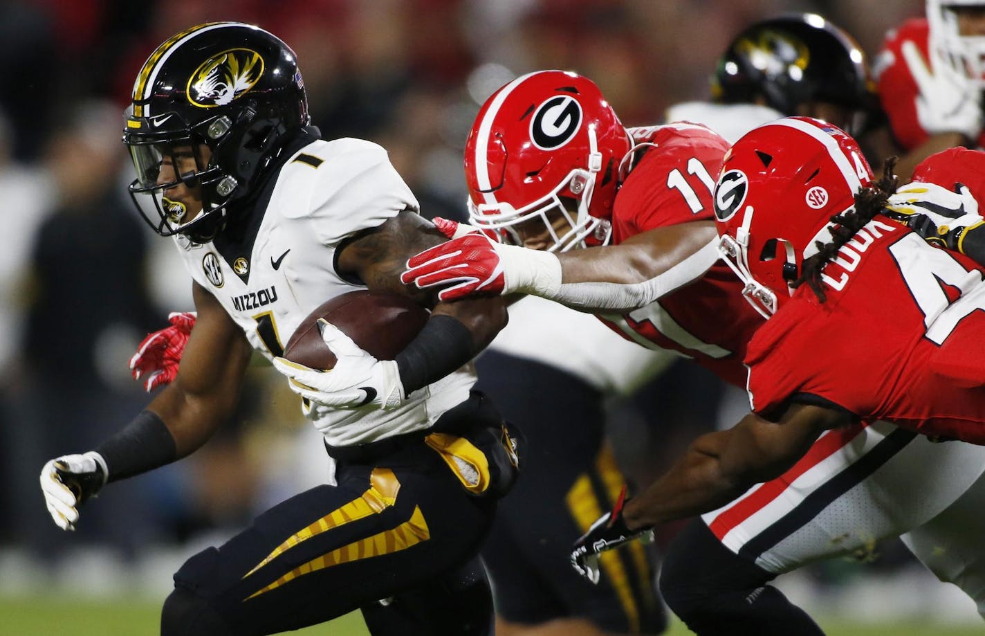 Missouri running back Tyler Badie (1) is taken down Georgia linebacker Jermaine Johnson (11) and Georgia running back James Cook (4) during a kickoff return in the first half Saturday. [Joshua L. Jones/GateHouse Media] ORG XMIT: 1486054