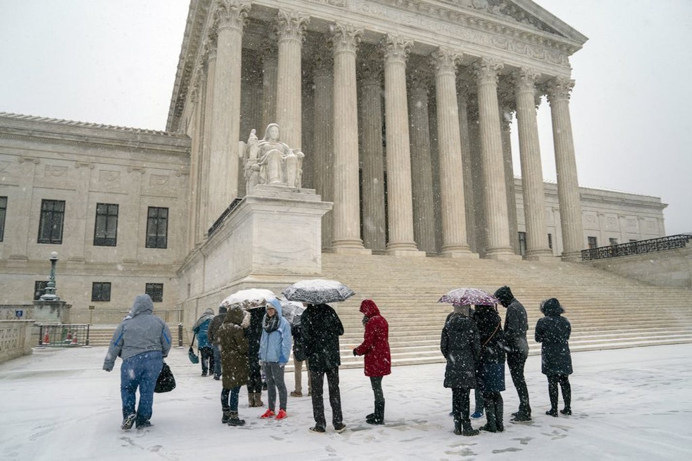 Visitors wait to enter the Supreme Court as a winter snow storm hits the nation's capital making roads perilous and closing most Federal offices and all major public school districts, on Capitol Hill in Washington, Wednesday, Feb. 20, 2019. The Supreme Court is ruling unanimously that the Constitution's ban on excessive fines applies to the states. The outcome Wednesday could help an Indiana man recover the $40,000 Land Rover police seized when they arrested him for selling about $400 worth of h