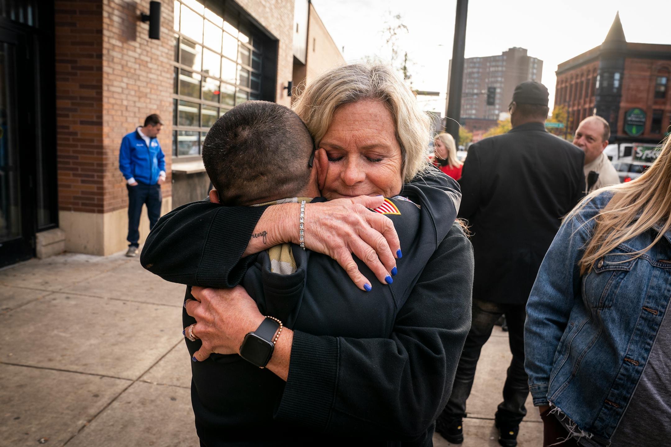 Jose Gato Benavides, left, who works at bars in the neighborhood, hugged Kim Firkus, who lives right above Seventh Street Truck Park outside Seventh Street Truck Park in St. Paul.
