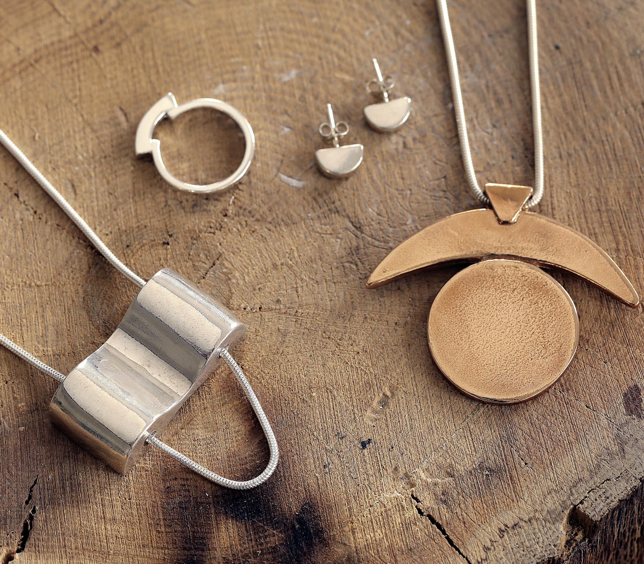 Two necklaces, a pair of earrings, and a ring, all by Lauren Neal.