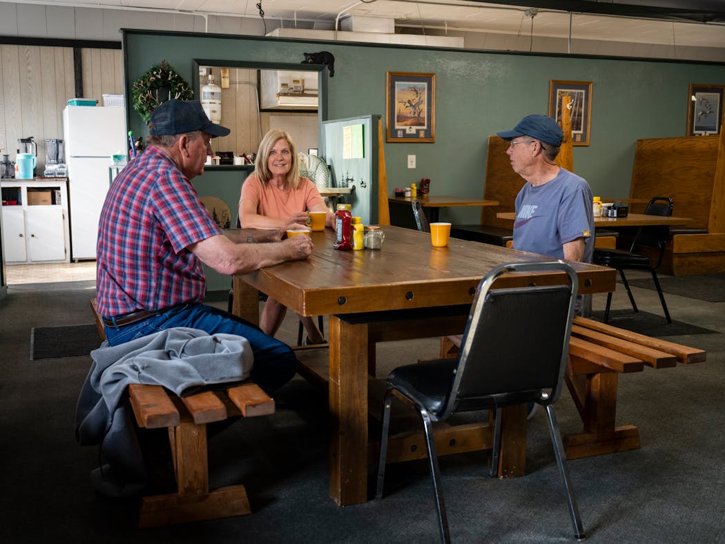 From left, Larry Erickson, Sue Bakko, and Bob Bailey having breakfast at the Hunting Shack Cafe in McHenry, N.D., on May 24, 2023. Most families in McHenry have known each other for decades, if not generations; the Hunting Shack cafe is the only business besides the bar on town’s main thoroughfare. 