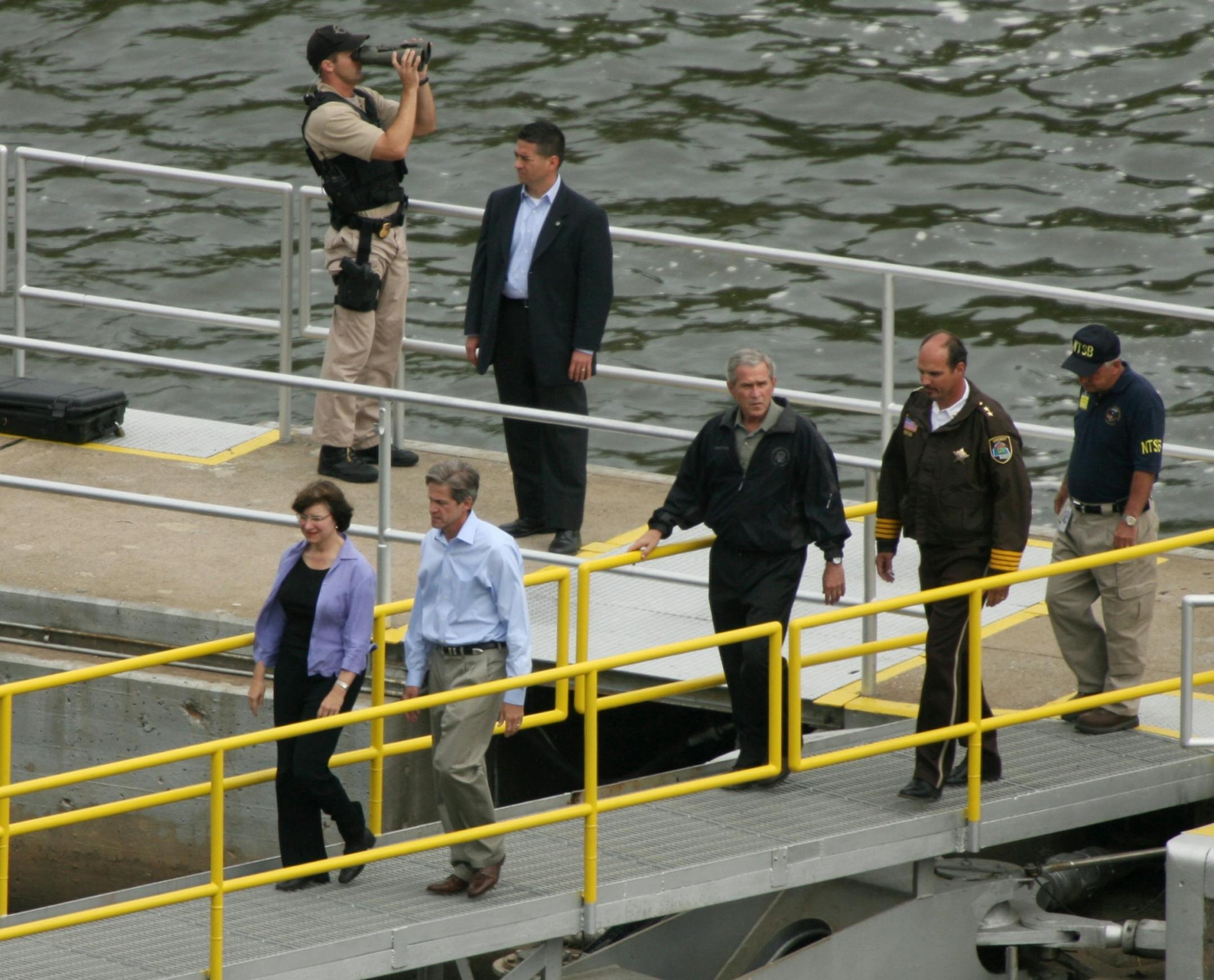 Minnesota Senators Amy Klobuchar, left, and Norm Coleman preceeded President George W. Bush across a foot bridge at the lock and dam near the I-35 bridge collapse in 2007.