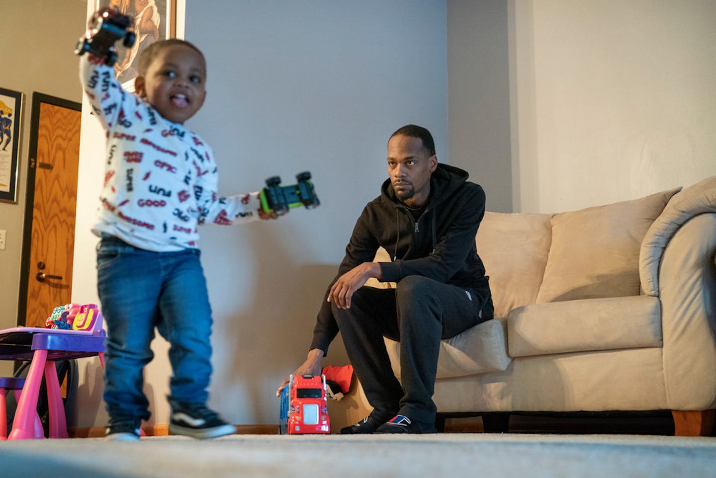 Shakir Gregg watched his 2-year-old son Cartier "Santana" Gregg play before heading to day care. Cartier lives with his grandfather, Nathaniel Hurse.