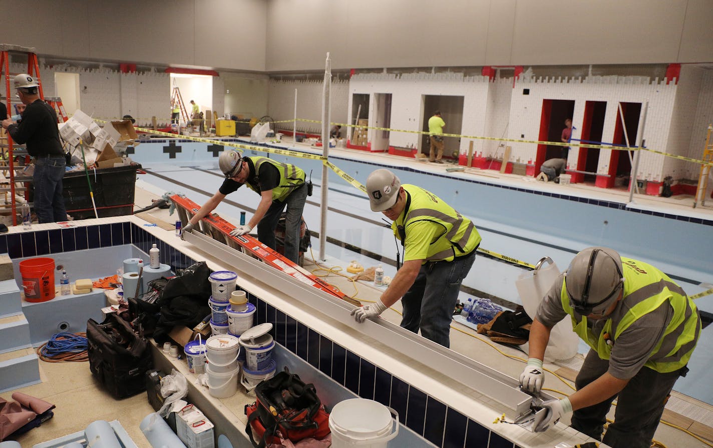 Construction workers installed part of the spa in the pool area which will open after the grand opening. ] ANTHONY SOUFFLE &#xef; anthony.souffle@startribune.com Workers readied the new YMCA on Nicollet Mall for it's opening later this week Wednesday, Jan. 24, 2018 in the Gaviidae Common building in downtown Minneapolis. The new $30 million space is five floors of the building and includes some national firsts including an equity innovation lab, a wellbeing center for yoga and meditation, a huge