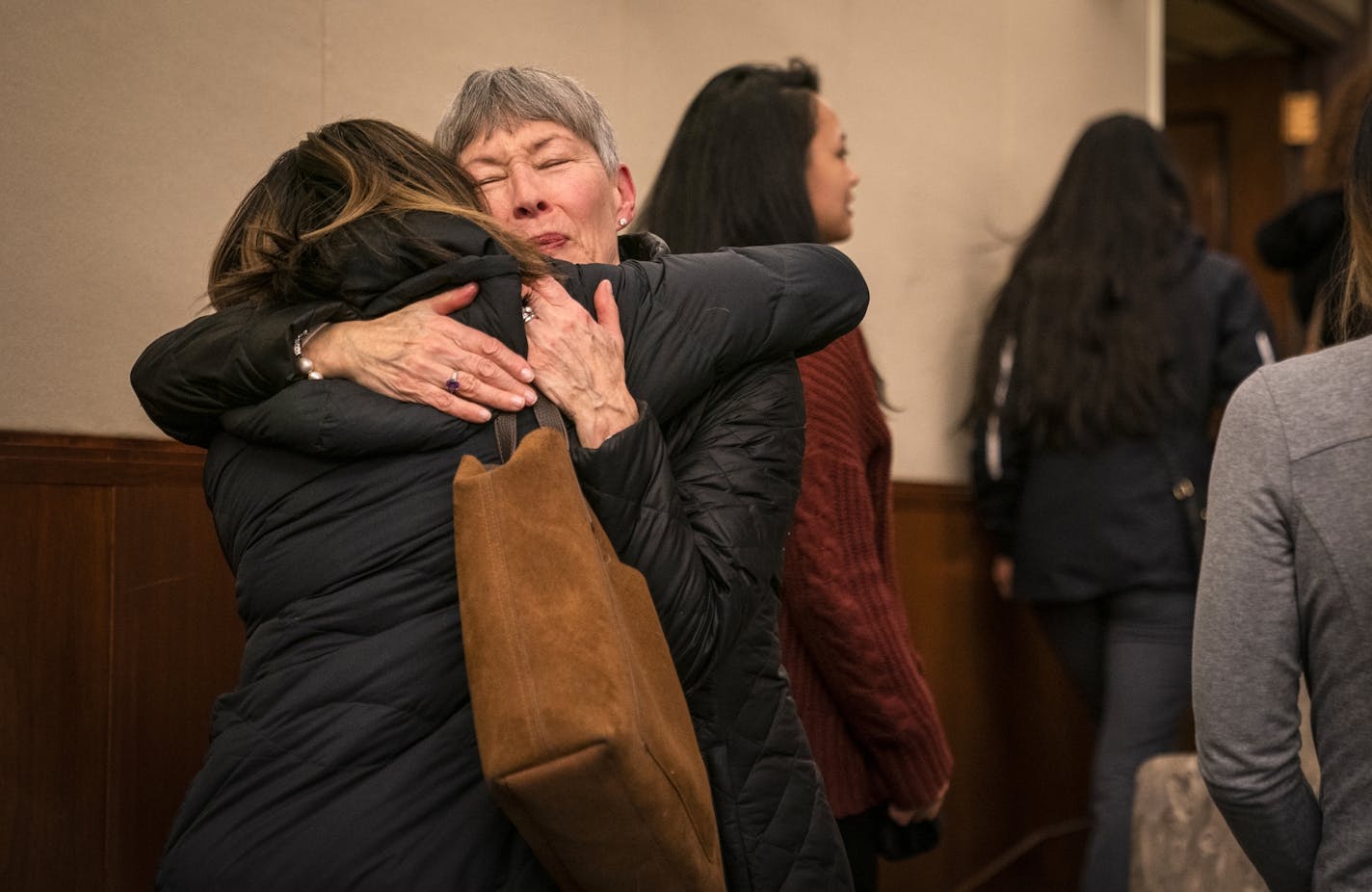 Linda Thompson, the former administrative assistant in the dental hygiene program at Argosy University, hugs a student after the hearing.