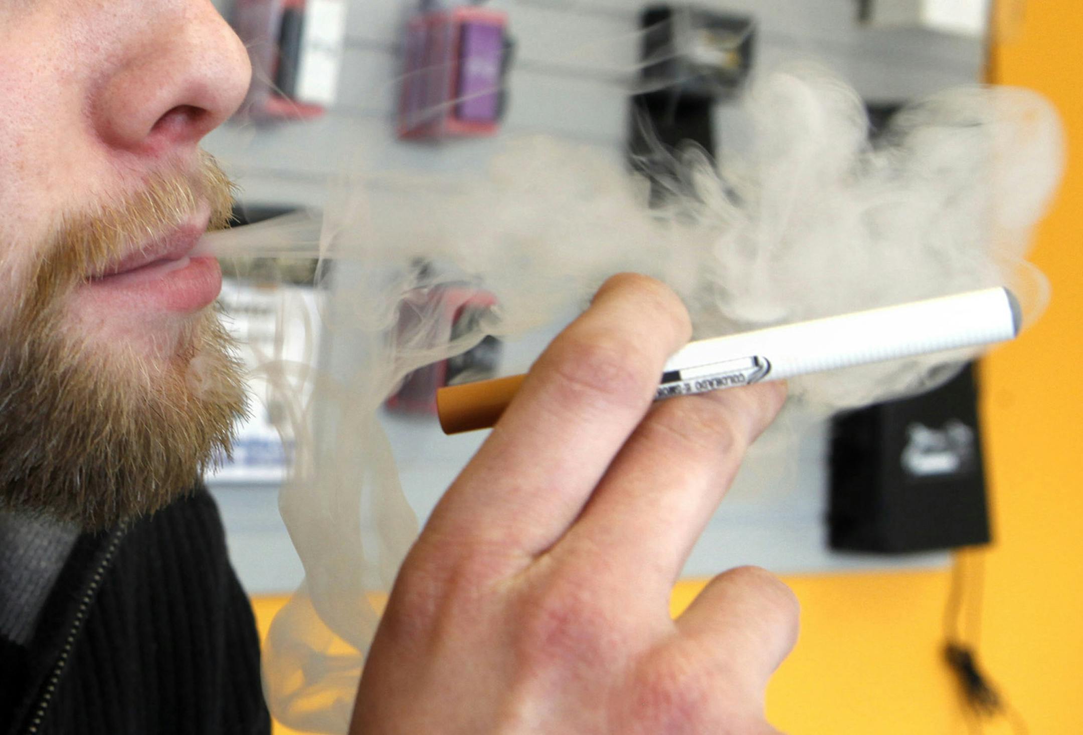 FILE - A sales associate demonstrates the use of a electronic cigarette and the smoke like vapor that comes from it in Aurora, Colo. on Wednesday, March 2, 2011. Children - like adults - are increasingly trying electronic cigarettes, according to the first large national study to gauge use by middle and high school students. About 2 percent of the students said they‚Äôd used an e-cigarette in the previous month, according to a survey done in 2012. That was up from 1 percent in 2