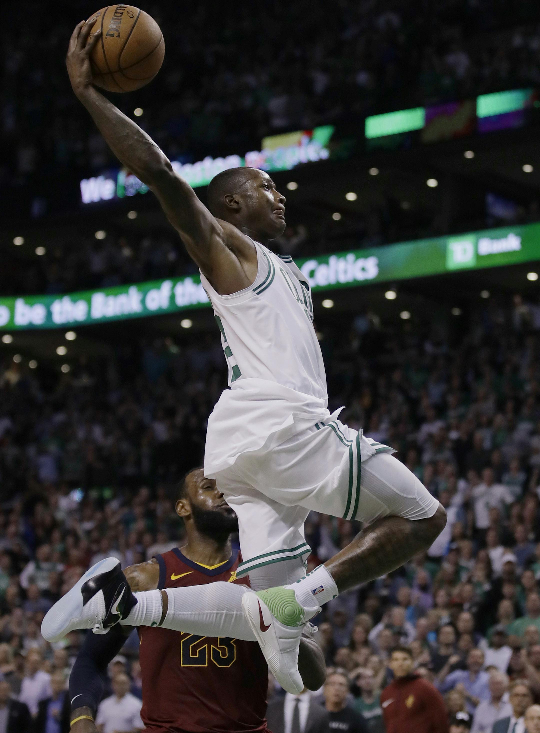 Boston Celtics guard Terry Rozier soars toward the basket past Cleveland Cavaliers forward LeBron James during the second half in Game 2 of the NBA basketball Eastern Conference finals, Tuesday, May 15, 2018, in Boston. (AP Photo/Charles Krupa)